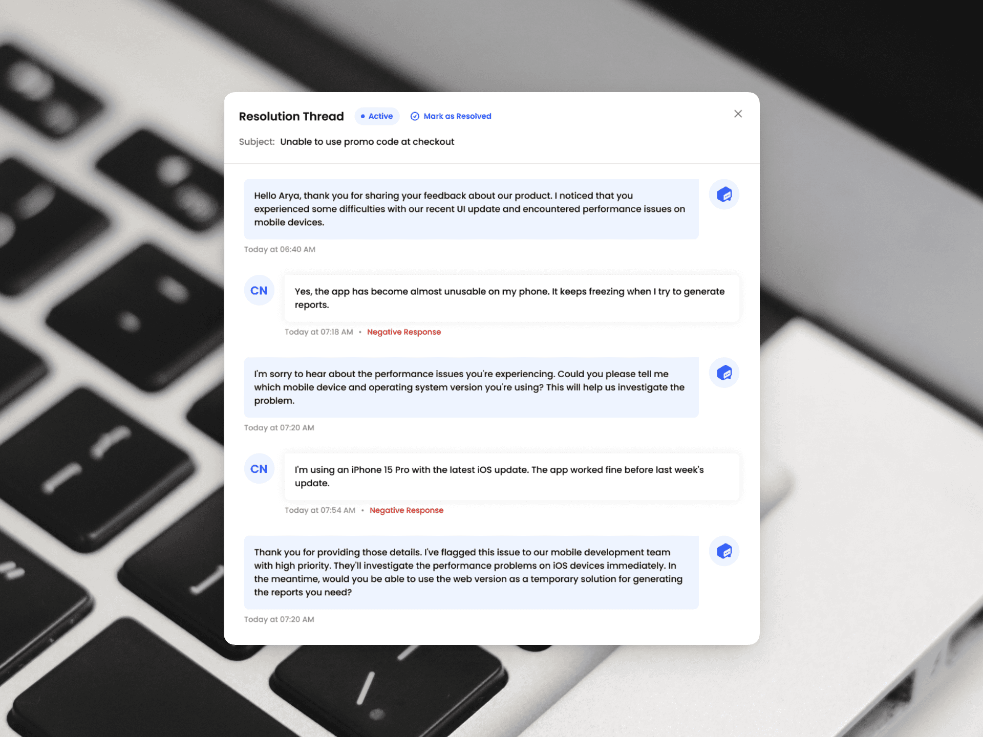 Screenshot of a FeedbackRobot AI-powered resolution thread showing a back-and-forth conversation between a customer and an automated response, overlaid on a photo of a keyboard.